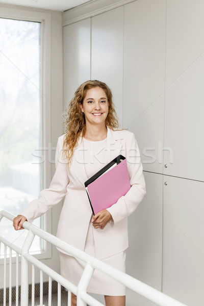 Successful businesswoman standing in hallway Stock photo © elenaphoto