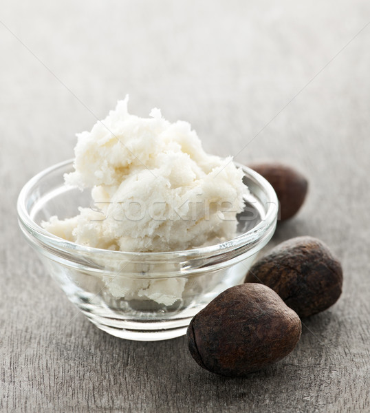 Shea butter and nuts in bowl Stock photo © elenaphoto