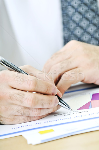 Stock photo: Office worker writing on reports