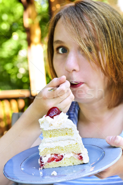 Girl eating a cake Stock photo © elenaphoto