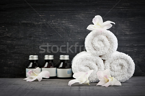 Rolled up towels and products at spa Stock photo © elenaphoto