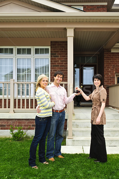 Stock photo: Happy couple with real estate agent