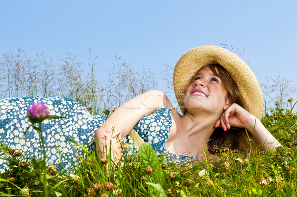 Young girl laying in meadow Stock photo © elenaphoto