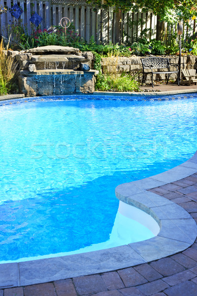 Swimming pool with waterfall Stock photo © elenaphoto
