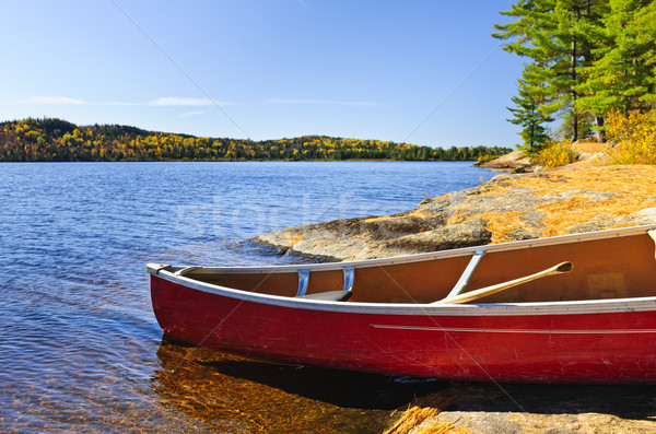 Red canoe on shore Stock photo © elenaphoto