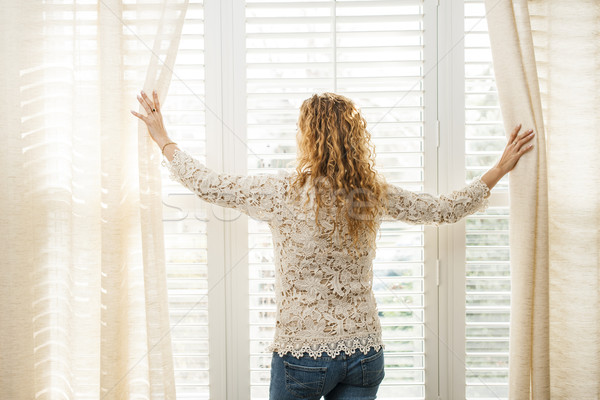 Woman looking out window Stock photo © elenaphoto