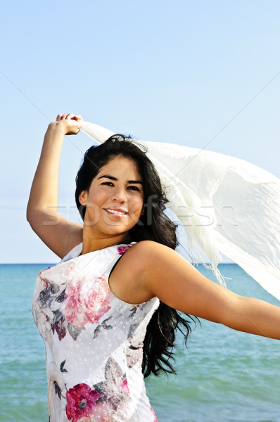 Beautiful young woman at beach with white scarf Stock photo © elenaphoto