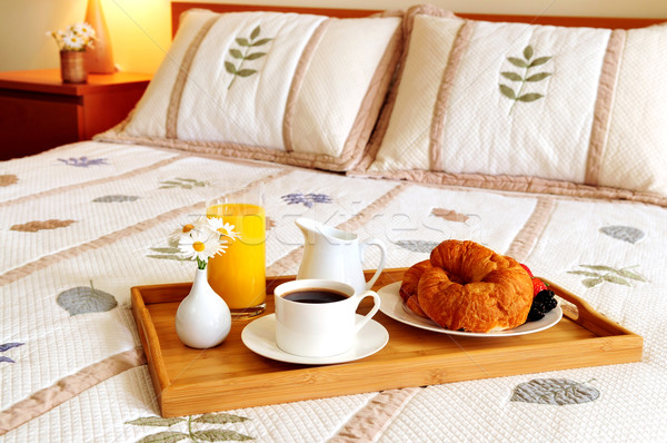 Breakfast on a bed in a hotel room Stock photo © elenaphoto