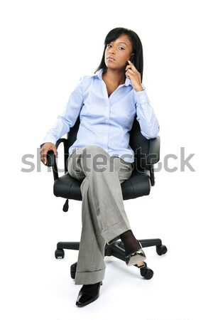 Businesswoman on phone sitting in office chair Stock photo © elenaphoto