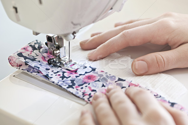 Hands with sewing machine Stock photo © elenaphoto