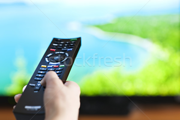 Hand with television remote control Stock photo © elenaphoto