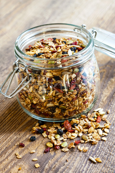 Homemade granola in open glass jar Stock photo © elenaphoto