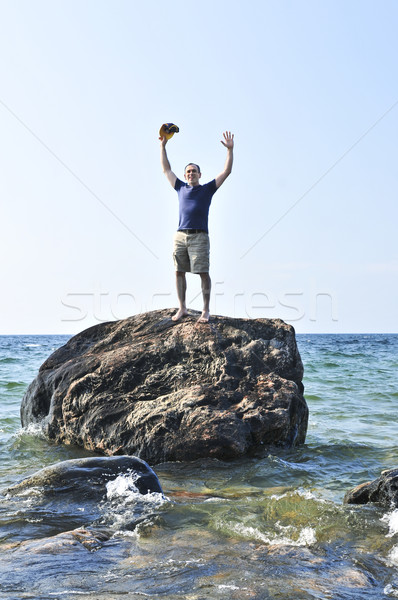 Man stranded on a rock in ocean Stock photo © elenaphoto