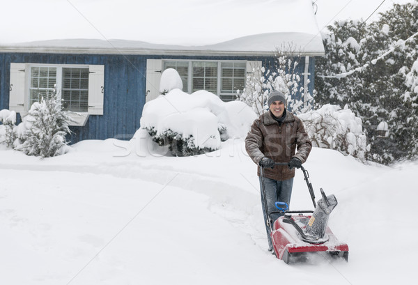 Man clearing driveway with snowblower Stock photo © elenaphoto