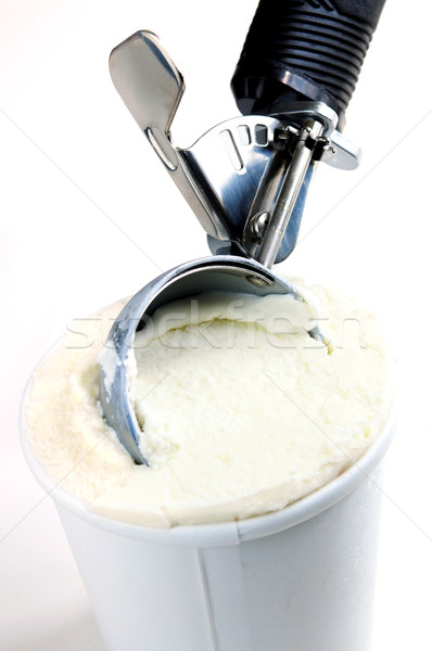 Stock photo: Tub of vanilla ice cream with a scoop