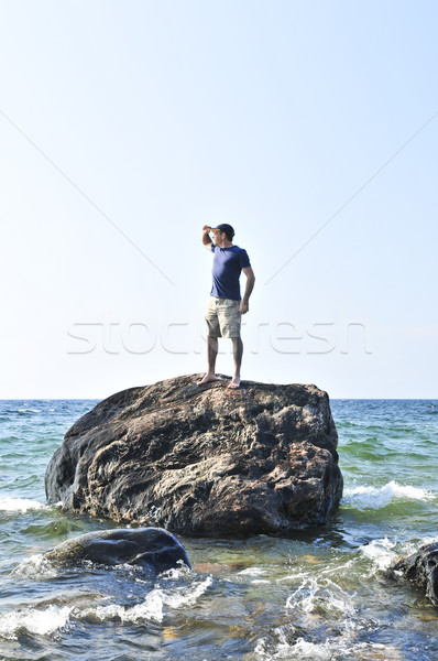 Man stranded on a rock in ocean Stock photo © elenaphoto