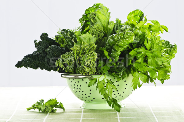 Dark green leafy vegetables in colander Stock photo © elenaphoto