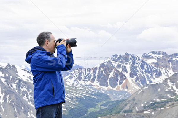 Photographer in mountains Stock photo © elenaphoto