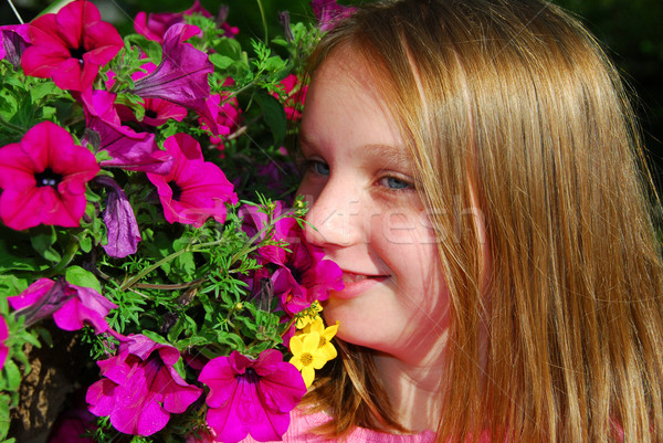 Young girl with flowers Stock photo © elenaphoto