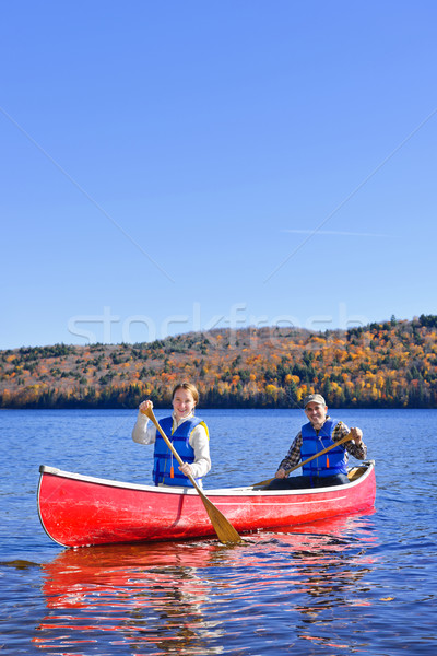 Canoe trip on scenic lake in fall Stock photo © elenaphoto
