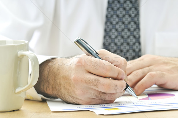 Stock photo: Office worker writing on reports