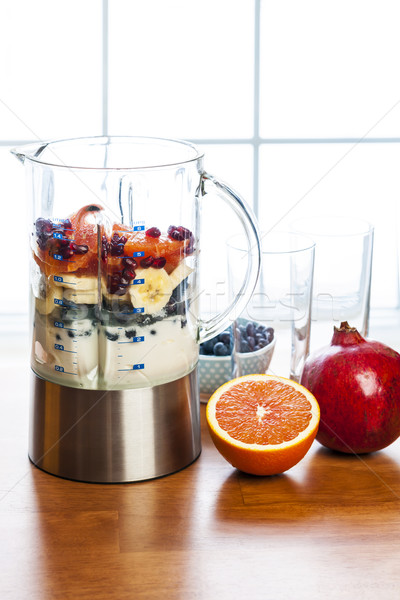Preparing smoothies with fruit and yogurt Stock photo © elenaphoto