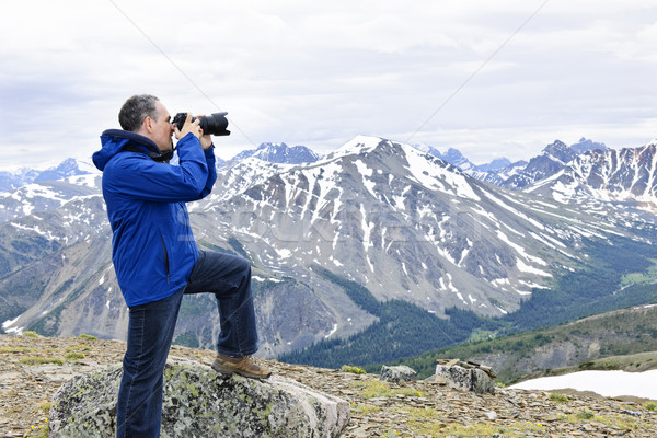 Photographer in mountains Stock photo © elenaphoto