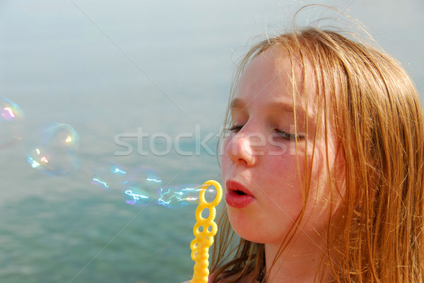 Girl blowing bubbles Stock photo © elenaphoto