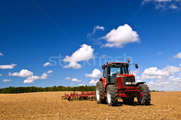 Tractor in plowed field Stock photo © elenaphoto