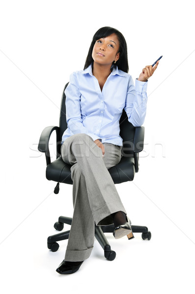 Thinking businesswoman sitting on office chair Stock photo © elenaphoto