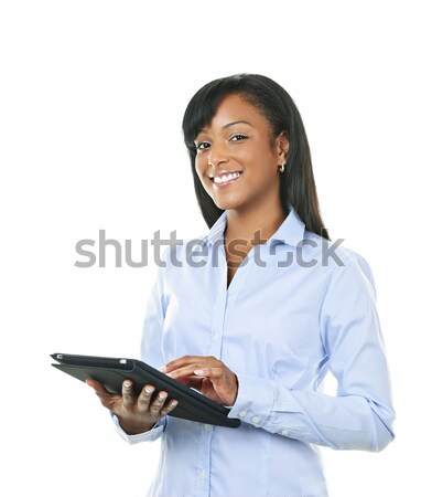 Smiling black businesswoman with arms crossed Stock photo © elenaphoto