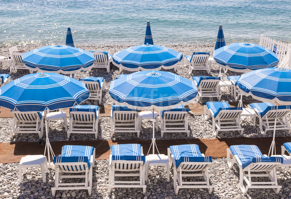 Blue beach umbrellas in Nice Stock photo © elenaphoto