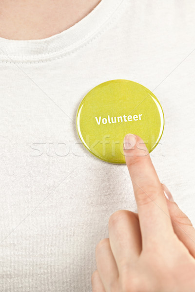Hand pointing to volunteer button Stock photo © elenaphoto