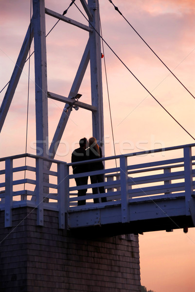 Couple kissing on a bridge Stock photo © elenaphoto