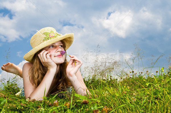 Young girl laying in meadow Stock photo © elenaphoto