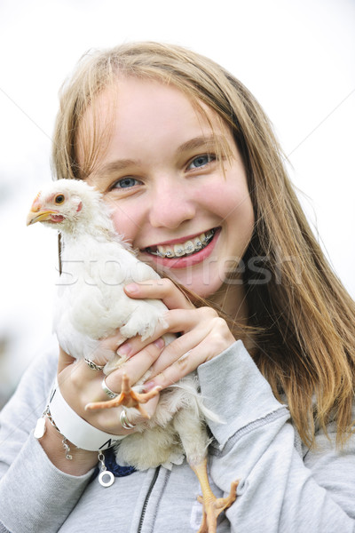 Teenage girl holding chicken Stock photo © elenaphoto