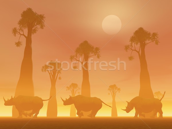 Rinoceronte corrida pôr do sol três árvores savana Foto stock © Elenarts