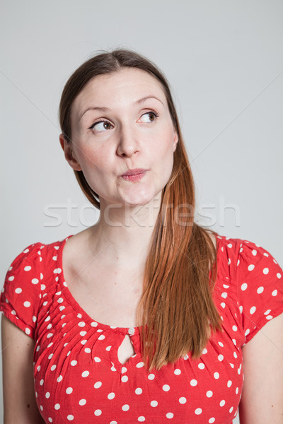 Stock photo: Thoughtful looking attractive woman