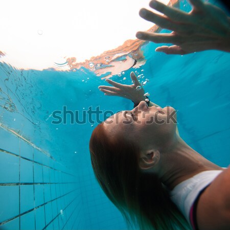 Female with eyes open underwater Stock photo © ElinaManninen