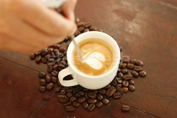 Barista creating a heart shaped coffee art design. Stock photo © ElinaManninen