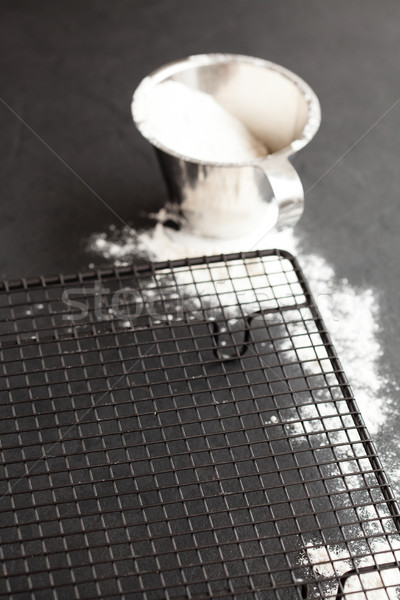 Stock photo: Cup of flour and mesh tray