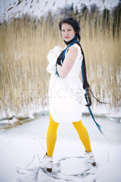 Woman wearing a stylish dress, scarf and ice skate. Stock photo © ElinaManninen