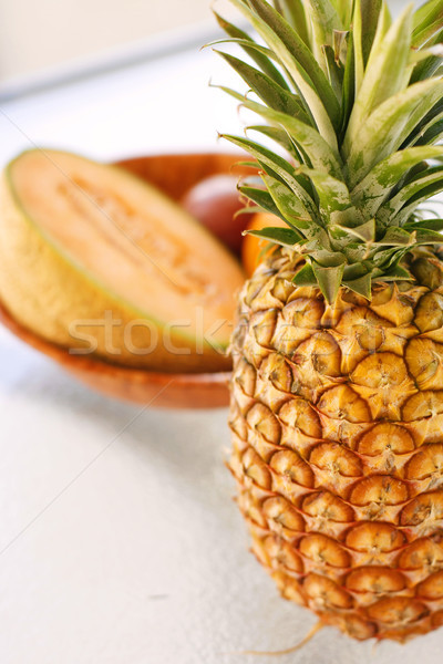 Színes trópusi gyümölcs egyezség üveg asztal ananász Stock fotó © ElinaManninen