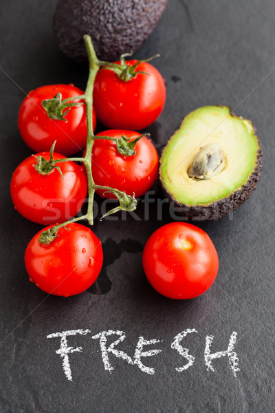 Fresh tomatoes and avocados Stock photo © ElinaManninen