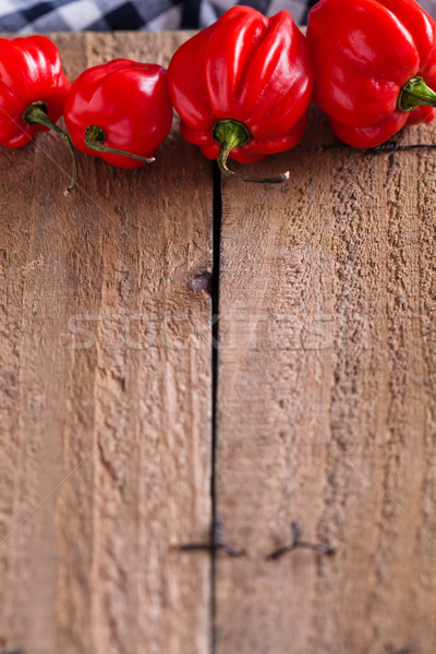 Red chili peppers on wooden board Stock photo © ElinaManninen