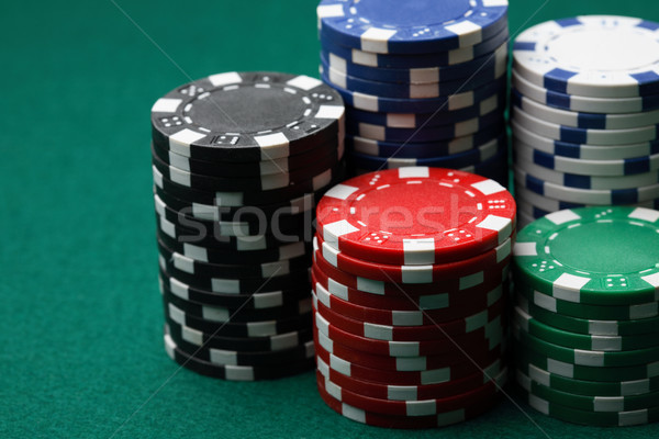Stacks of poker chips on a green surface. Stock photo © ElinaManninen
