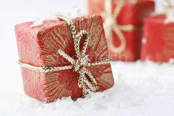 Stock photo: Christmas gifts with red wrapping and decorative bows.