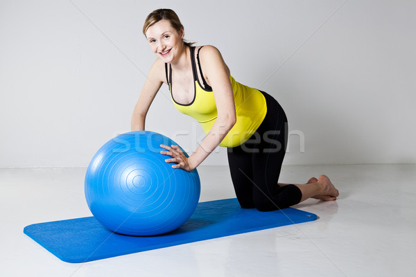 Pregnant woman doing push-up exercise Stock photo © ElinaManninen