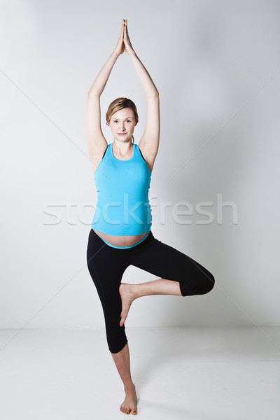 Pregnant woman doing yoga exercise Stock photo © ElinaManninen
