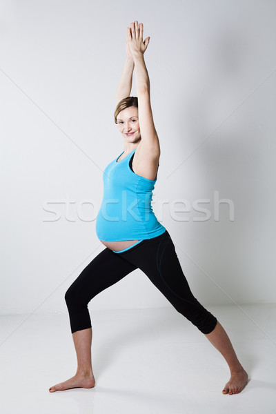 Pregnant woman doing yoga exercise Stock photo © ElinaManninen